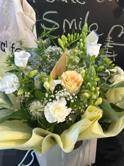 Champagne Whisper - A graceful bouquet of soft cream, white and warm champagne tones, finished with abundant fresh greenery.